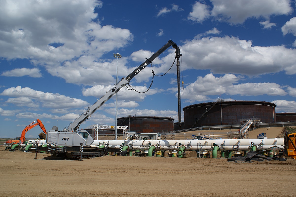 Helical piles over pipes