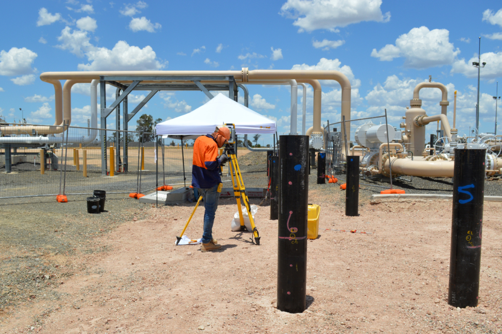 Surveyor laying out piles
